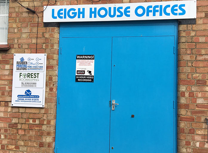 Doorway showing overhead sign and one to the left supplied and installed by Luxe Graphics, Desborough Sign company